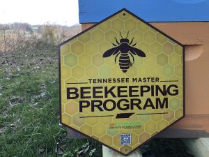A honey bee on the MBP apiary sign