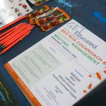 flyer, pens, and bookmark on table