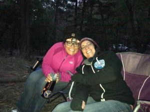 Sandra Pena and a friend camping at night